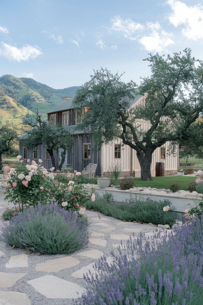 Farmhouse garden with a stone path, lavender borders, roses, and mature trees next to a wooden house.